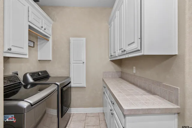 a kitchen with granite countertop a sink stove and cabinets