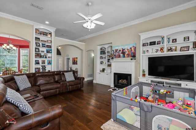 a living room with furniture a flat screen tv and a fireplace