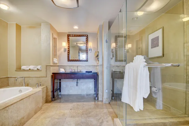 a bathroom with a tub sink and mirror