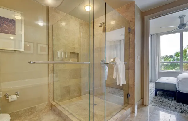 a bathroom with a glass shower door and a glass door shower