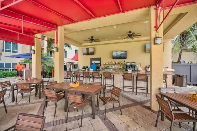 a view of a patio with dining table and chairs