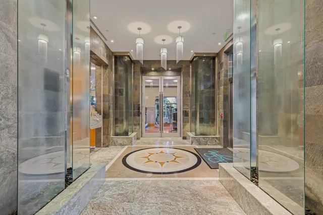 a bathroom with a granite countertop tub shower and mirror