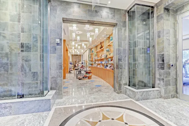a bathroom with a granite countertop tub shower and sink