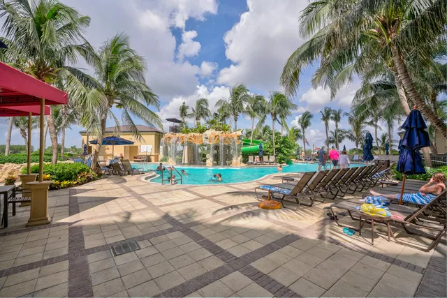 a row of palm trees in front of house