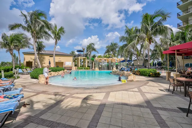 a row of palm trees sitting in front of building