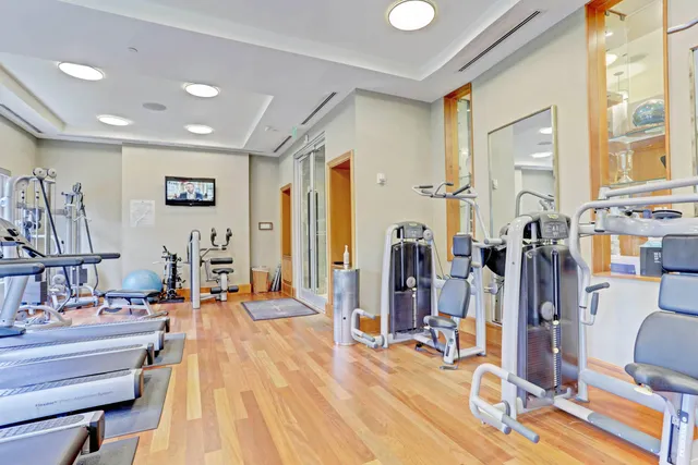 front view of a house with a yard and potted plants