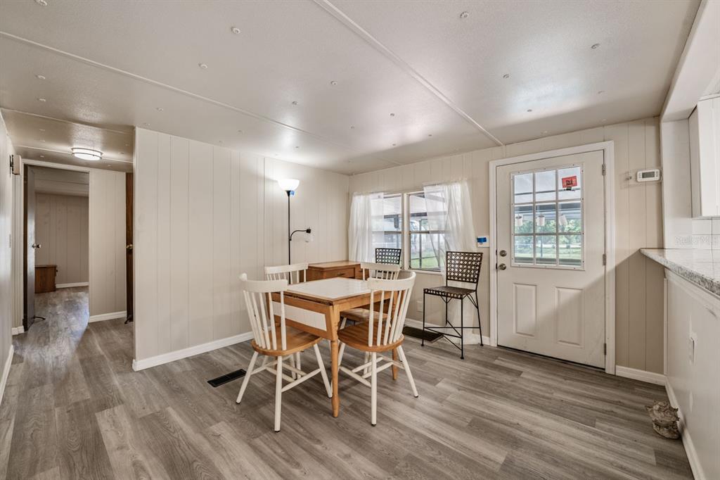 9739 Ray Street Hudson, FL 34669 - Photo 19 of 36 a view of a dining room with furniture and wooden floor