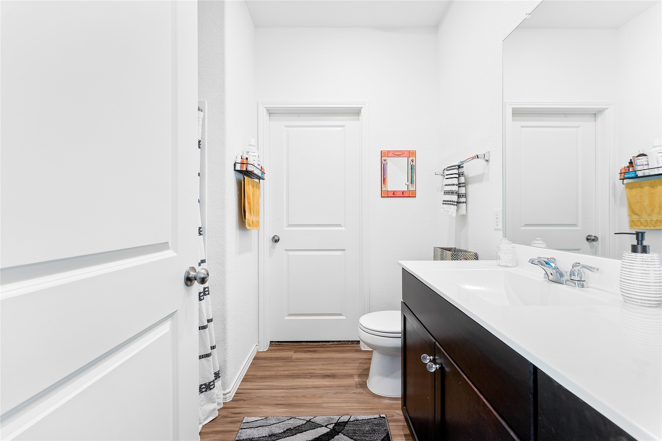 6009 Jagger Avenue Austin, TX 78747 - Photo 17 of 24 a bathroom with a sink a toilet and shower