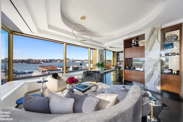 a living room with furniture and a kitchen view