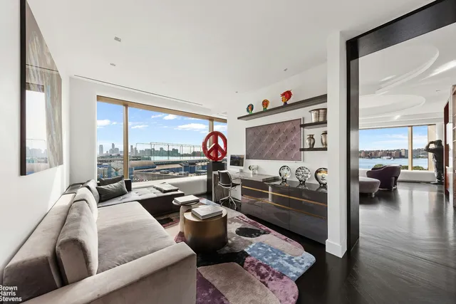 a bedroom with a large bed and a large window with outer view