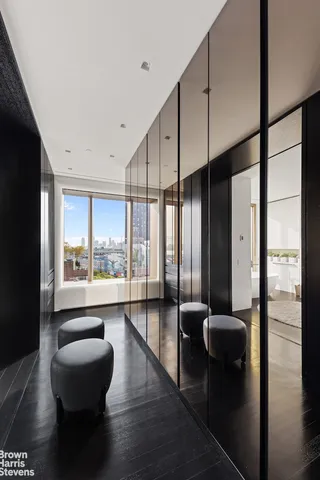 a bathroom with a tub and a view of living room