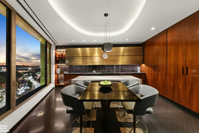 a view of a balcony with chairs and wooden floor