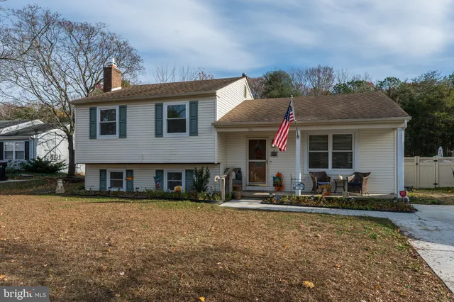a front view of house with yard outdoor seating and barbeque oven