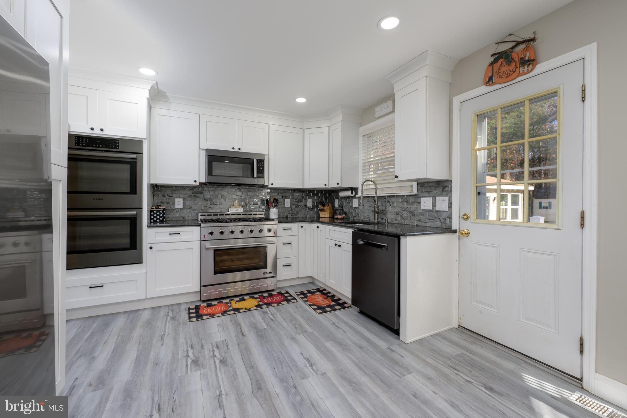 28 Mary Ellen Lane Sicklerville, NJ 08081 - Photo 9 of 46 a kitchen with granite countertop a stove top oven and cabinets