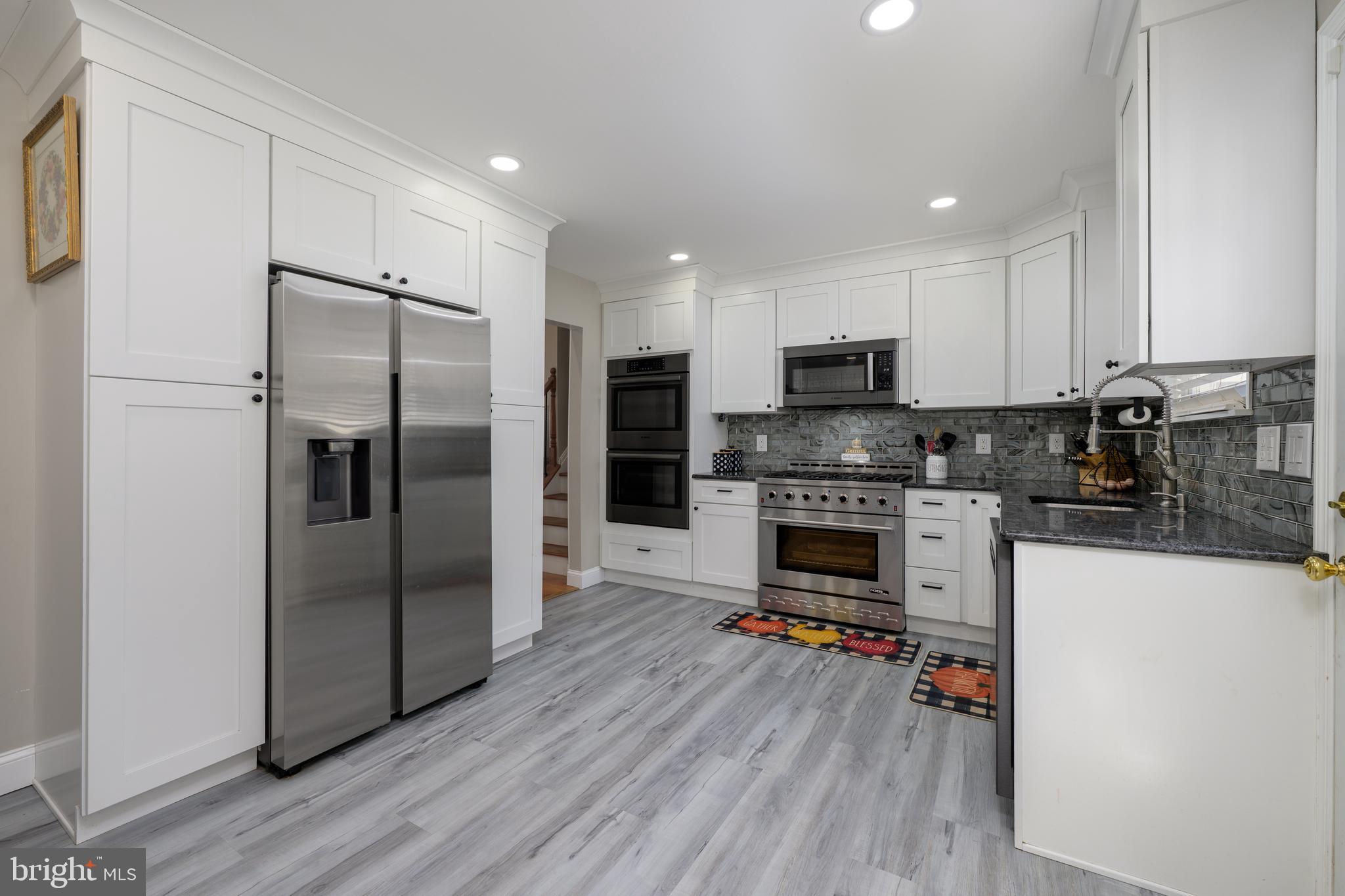 28 Mary Ellen Lane Sicklerville, NJ 08081 - Photo 10 of 46 a kitchen with granite countertop a refrigerator and a stove top oven
