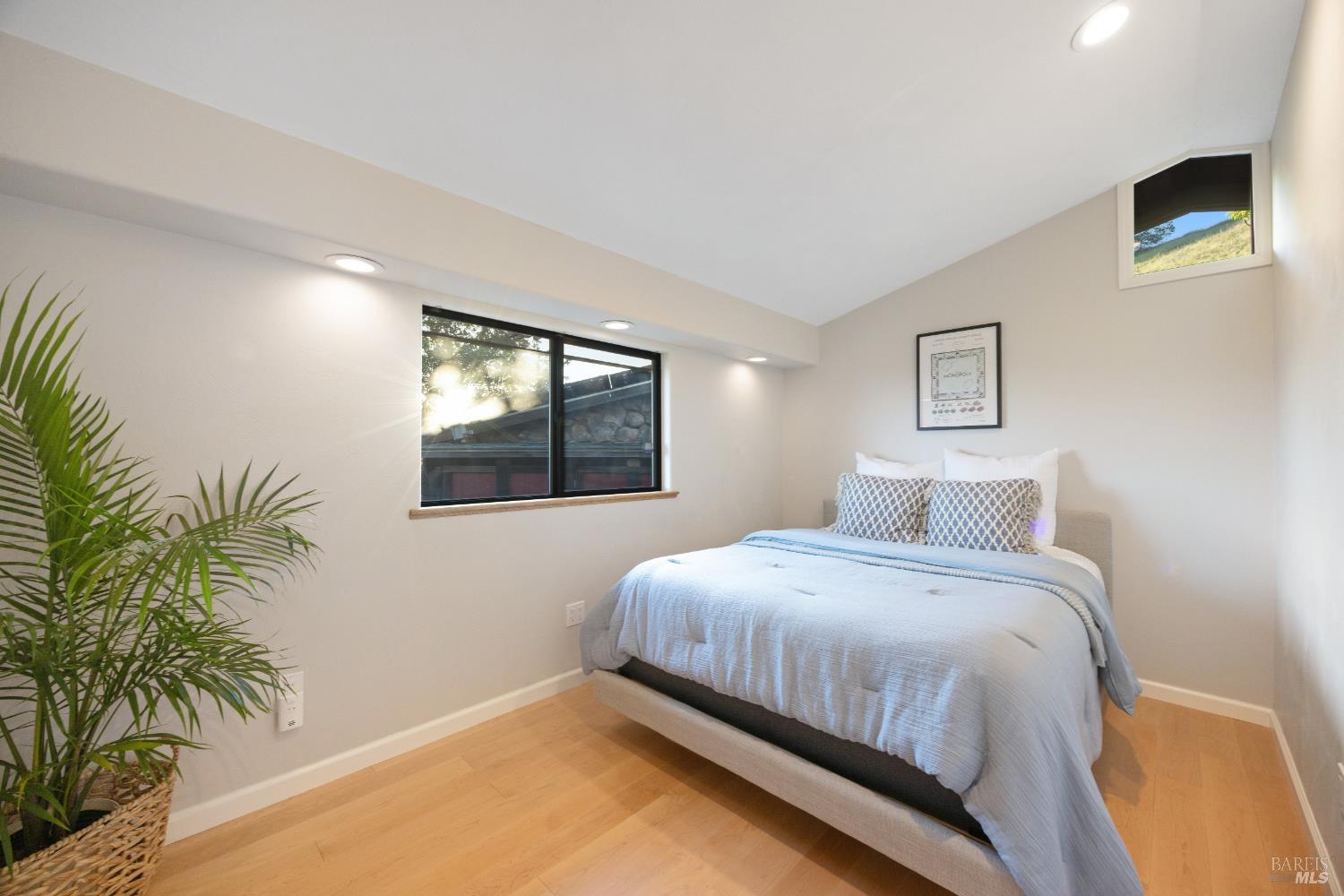 6960 Round Oak Road Penngrove, CA 94951 - Photo 30 of 58 a bedroom with a bed and a potted plant