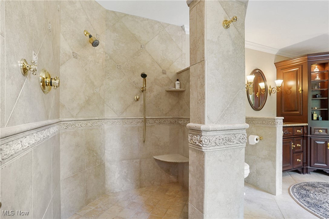 4432 Ira Road Akron, OH 44333 - Photo 27 of 50 Full bathroom featuring a walk in shower, crown molding, vanity, and tile walls