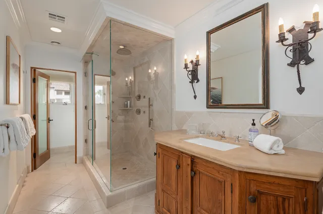 a bathroom with a granite countertop sink mirror and double