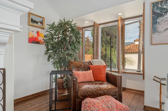 a living room with furniture and a potted plant