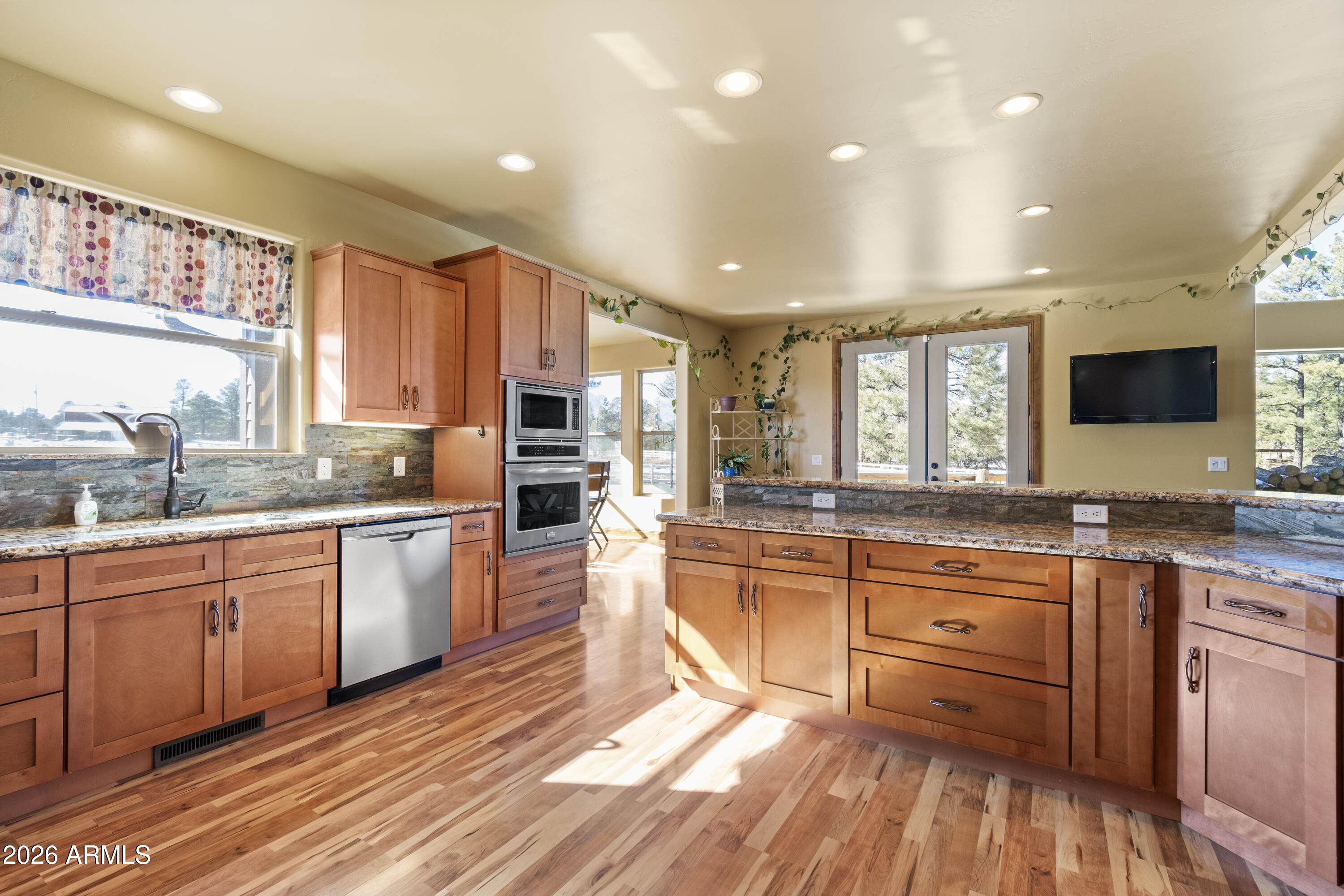 816 Fern Way Show Low, AZ 85901 - Photo 16 of 88 a large kitchen with stainless steel appliances granite countertop a large center island and a sink