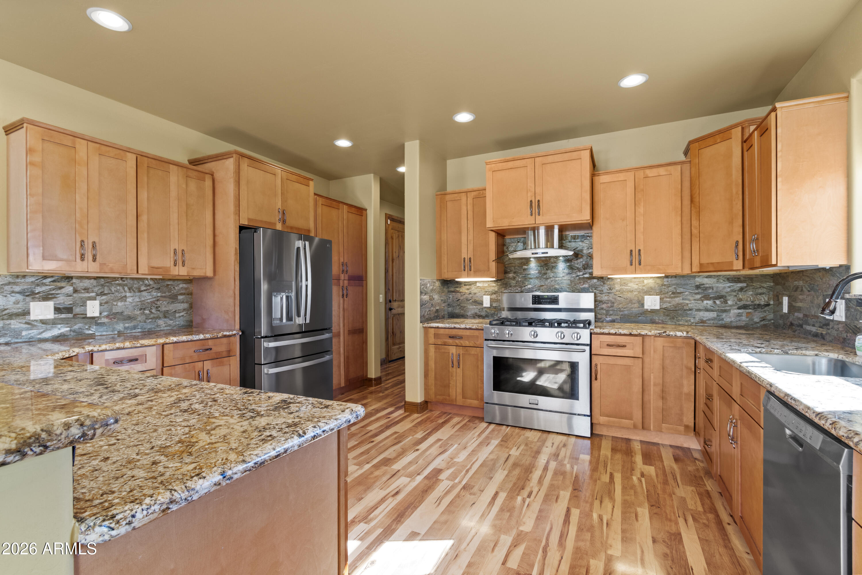 816 Fern Way Show Low, AZ 85901 - Photo 16 of 93 a kitchen with stainless steel appliances granite countertop a sink stove and refrigerator