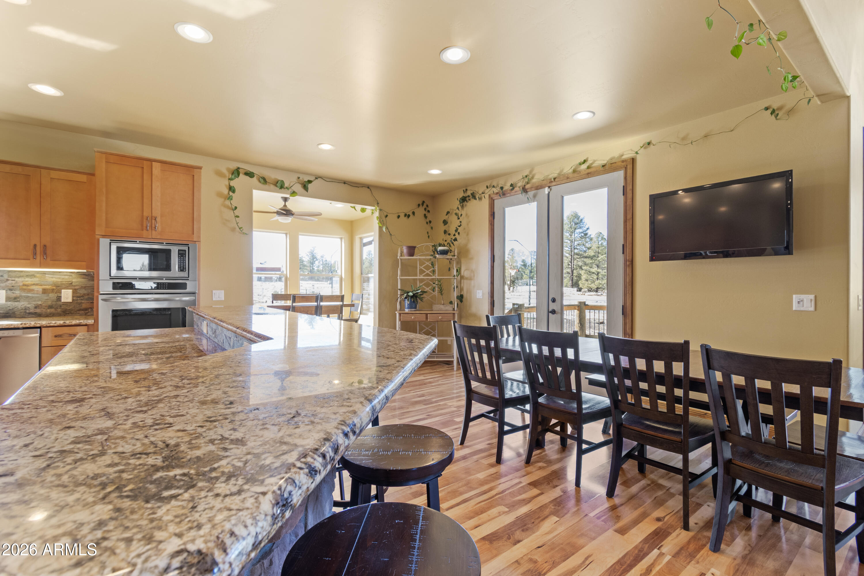 816 Fern Way Show Low, AZ 85901 - Photo 19 of 93 a view of a dining room with furniture window and wooden floor