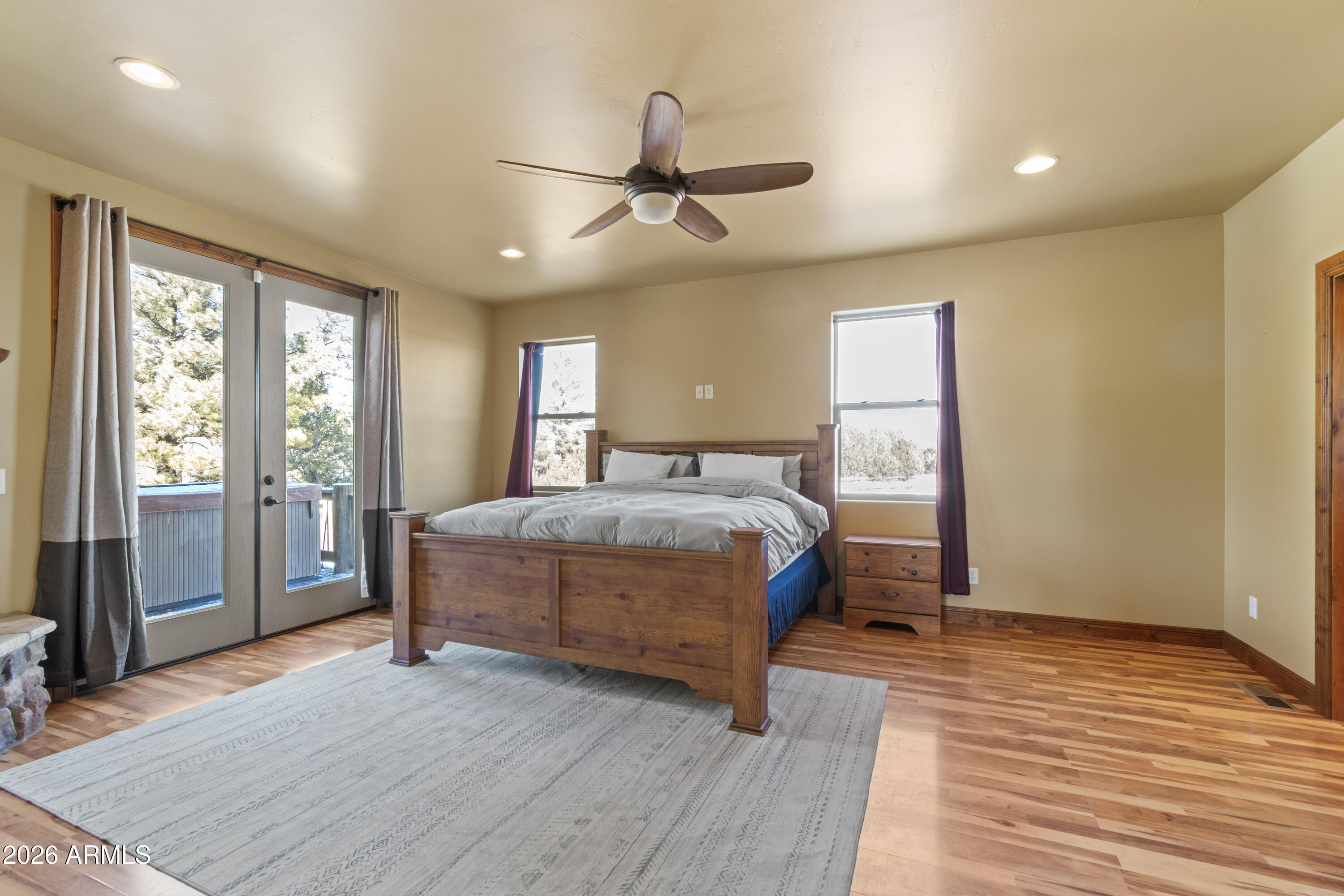 816 Fern Way Show Low, AZ 85901 - Photo 22 of 88 a bedroom with a large bed and wooden floor