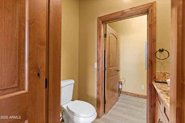 a bathroom with a granite countertop sink and a bathtub