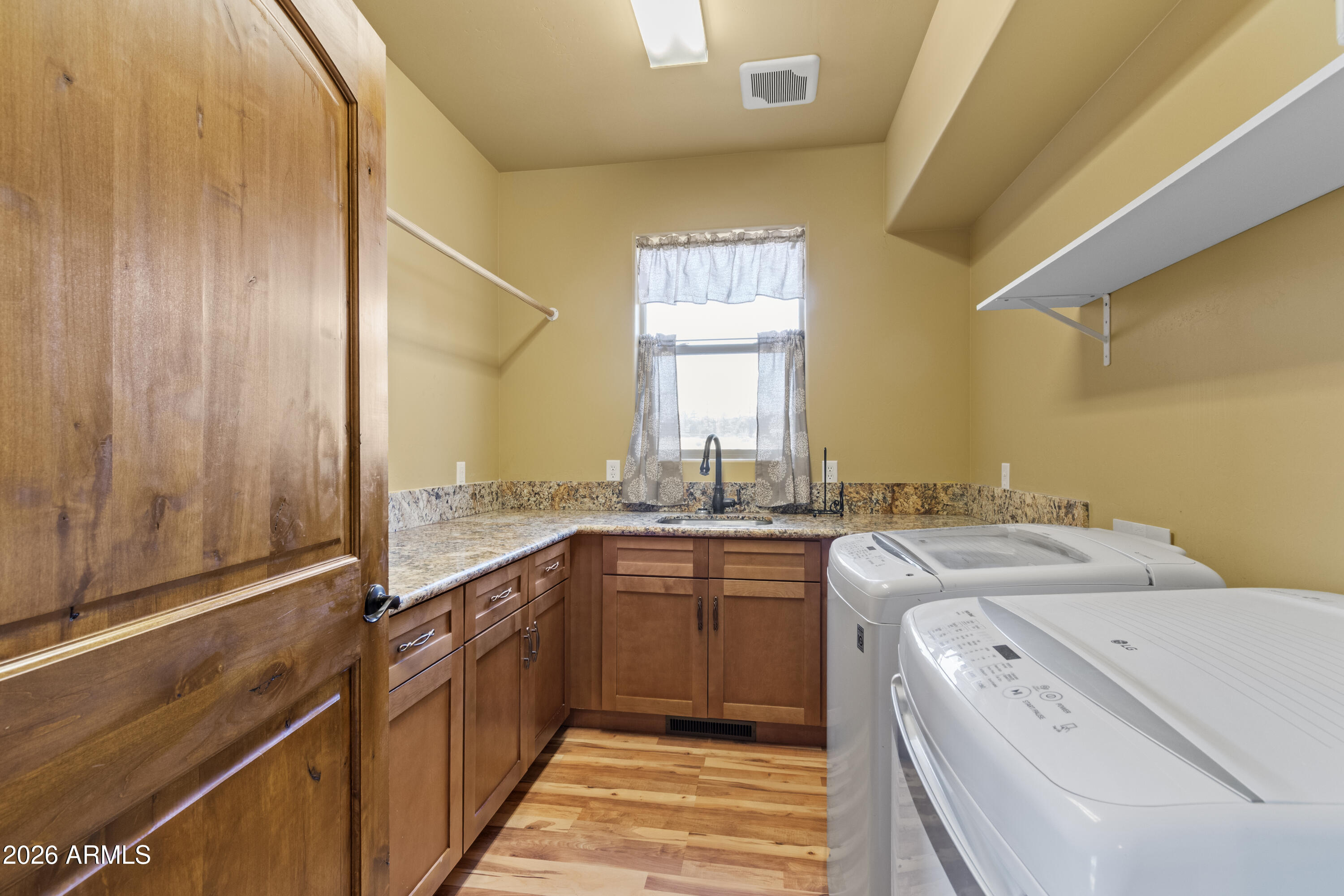 816 Fern Way Show Low, AZ 85901 - Photo 32 of 93 a kitchen with a sink cabinets and wooden floor