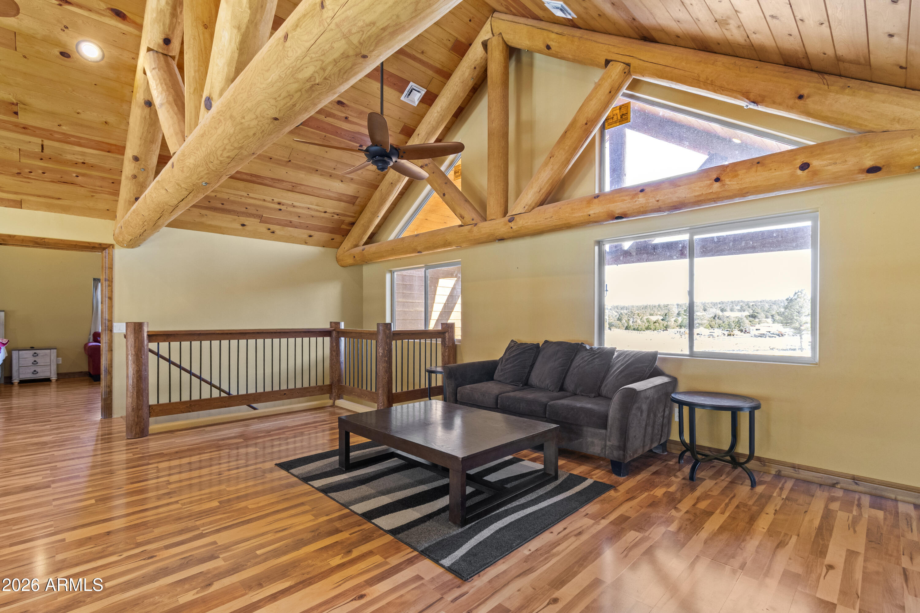 816 Fern Way Show Low, AZ 85901 - Photo 36 of 88 a living room with furniture a wooden floor and next to a window