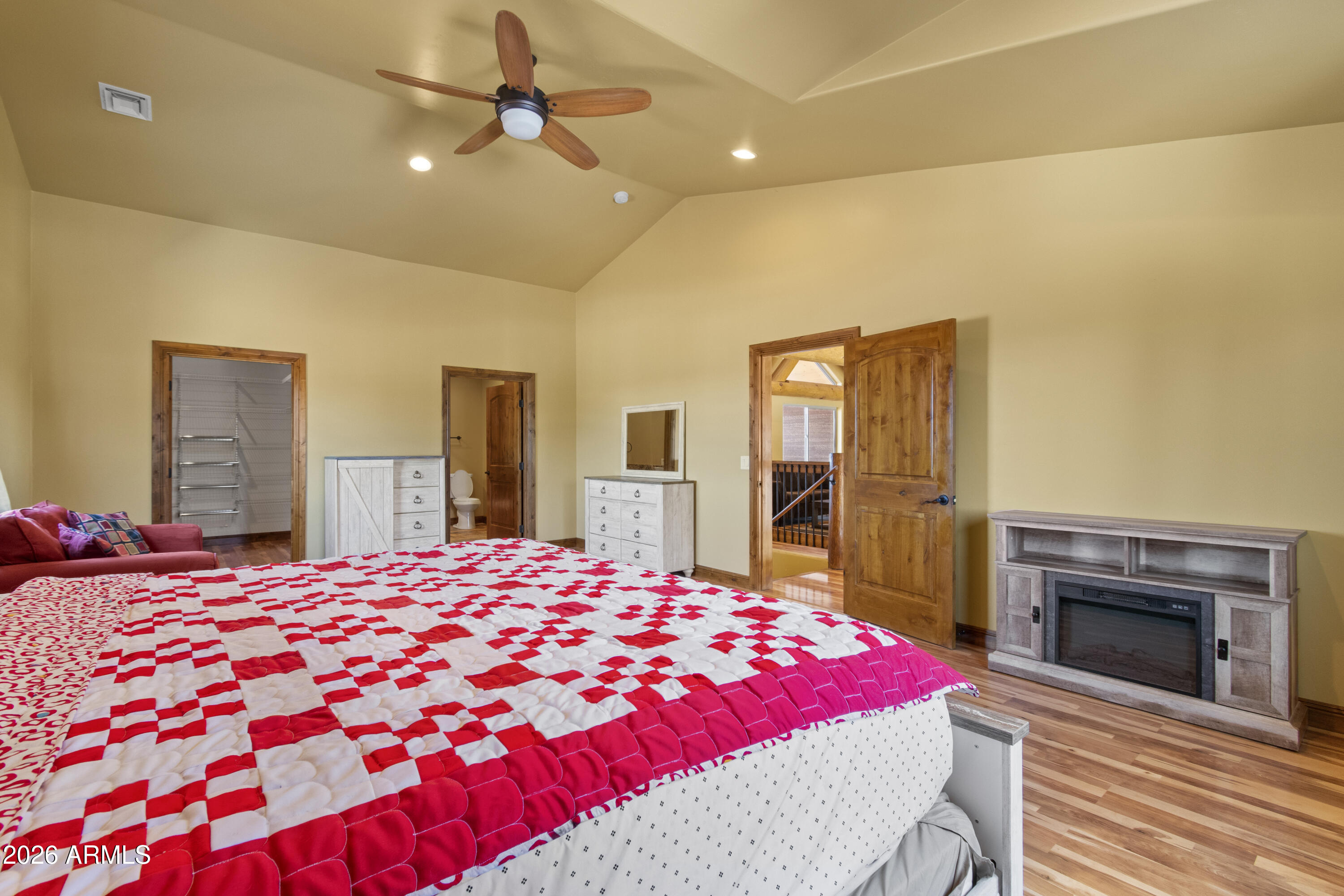 816 Fern Way Show Low, AZ 85901 - Photo 43 of 93 a bedroom with a large bed and a fireplace