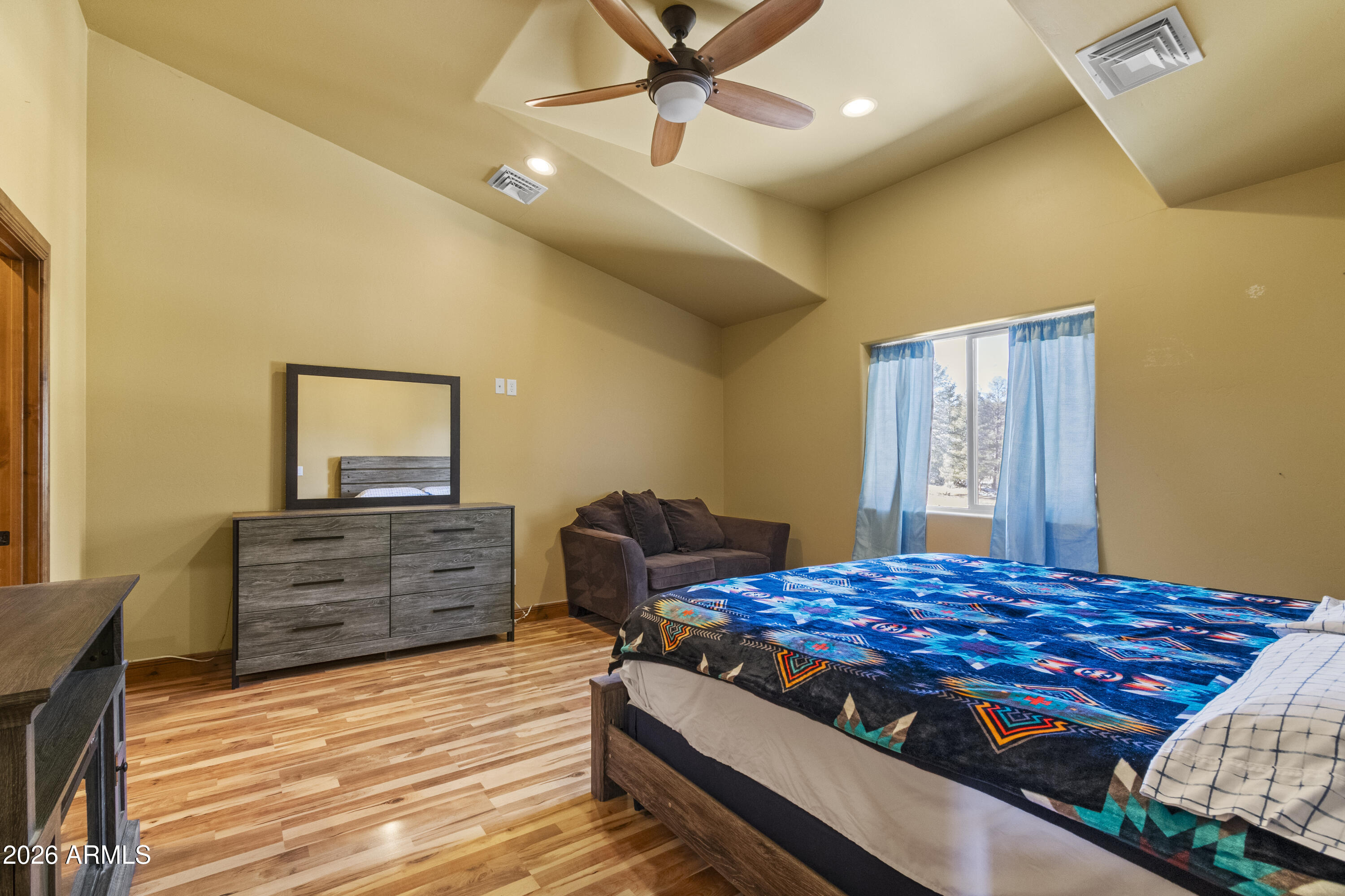 816 Fern Way Show Low, AZ 85901 - Photo 55 of 93 a bedroom with a bed and wooden floor