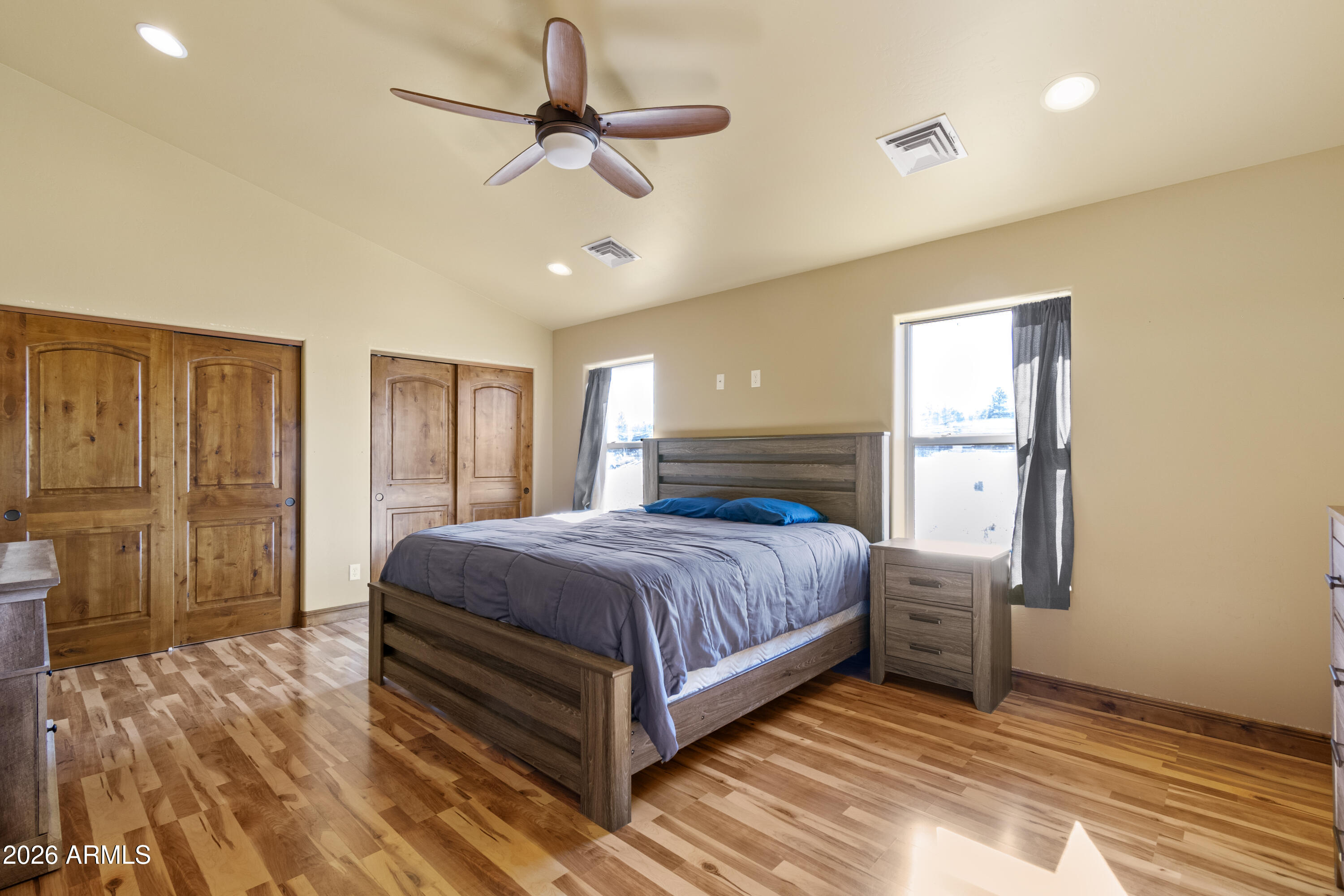 816 Fern Way Show Low, AZ 85901 - Photo 58 of 88 a spacious bedroom with a bed and a chandelier