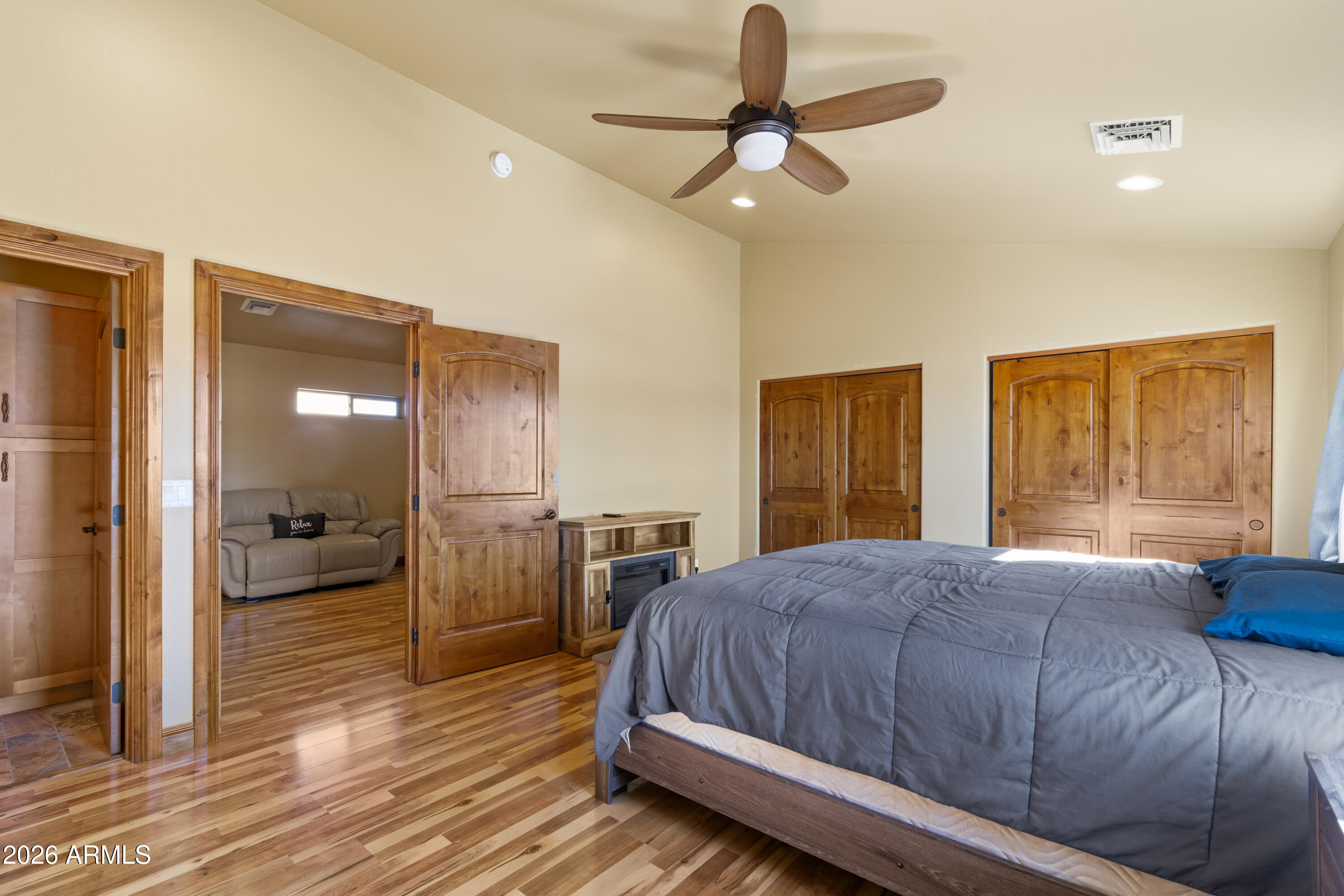 816 Fern Way Show Low, AZ 85901 - Photo 60 of 88 a bedroom with a bed and a large window with wooden floor