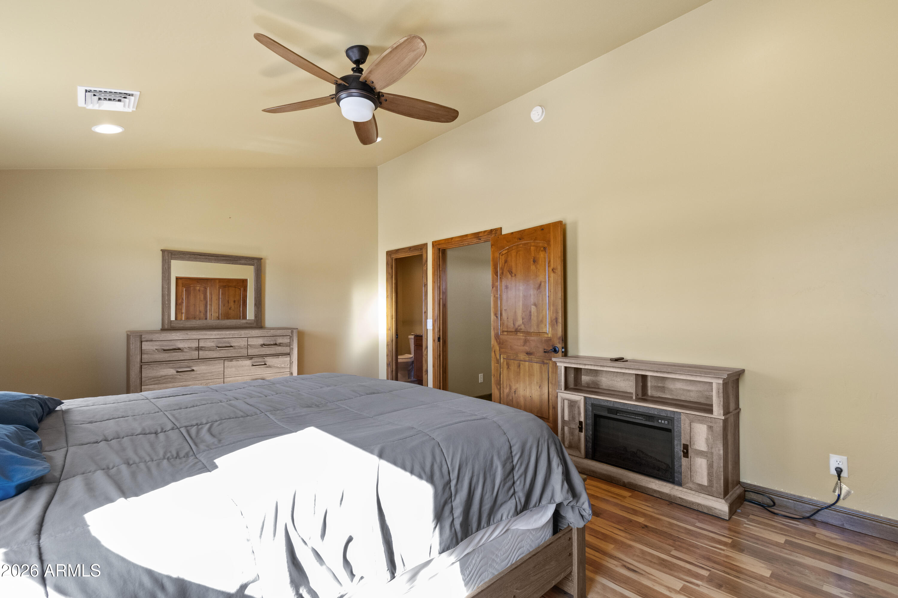 816 Fern Way Show Low, AZ 85901 - Photo 61 of 88 a bedroom with a bed and a chandelier