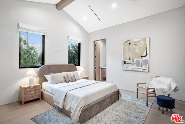 a bathroom with a granite countertop sink a toilet and shower