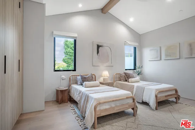 a spacious bathroom with a double vanity sink a mirror and a shower