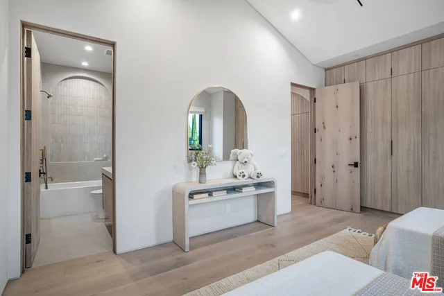 a spacious bedroom with a bed and a large window