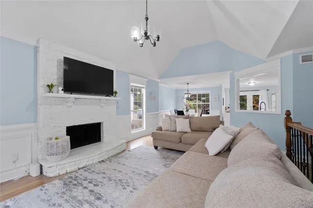 a living room with furniture a fireplace and a flat screen tv