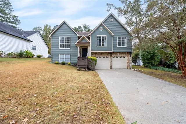 a front view of a house with a yard and garage