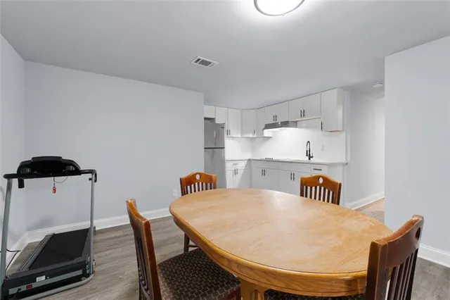 a kitchen with cabinets a refrigerator and a sink
