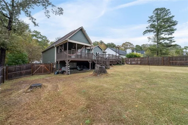 a view of a house with furniture and a small yard