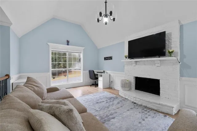 a living room with furniture a fireplace and a flat screen tv
