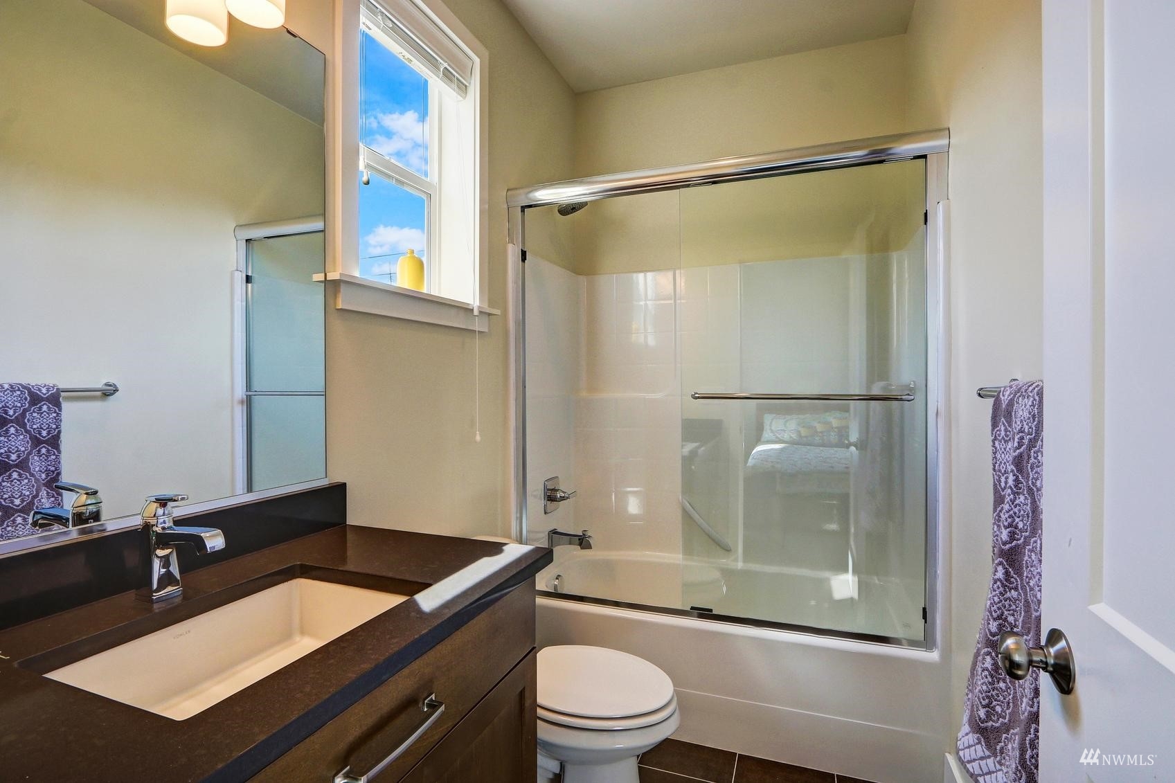4321 231st Place Southeast Bothell, WA 98021 - Photo 28 of 40 a bathroom with a granite countertop sink toilet a mirror and shower