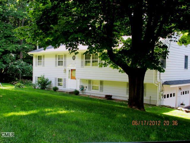 95 Hobby Drive Ridgefield, CT 06877 - Photo 1 of 1 a front view of a house with a yard