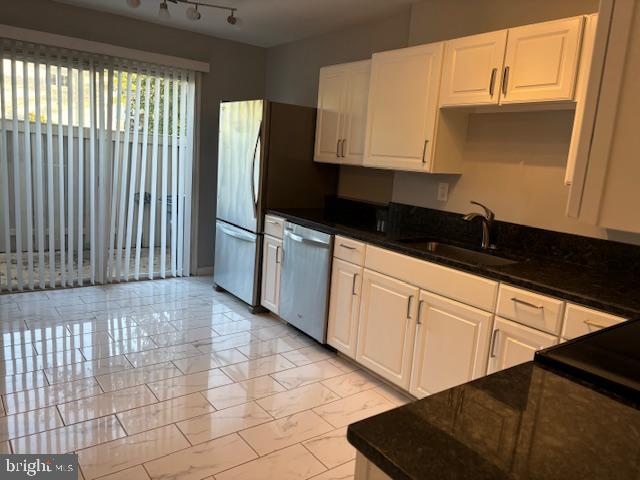7900 Spring Forest Court Springfield, VA 22152 - Photo 10 of 40 a kitchen with a sink a refrigerator and cabinets