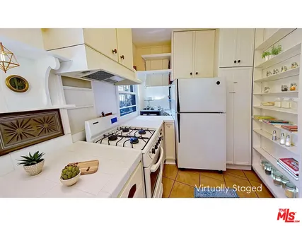 a kitchen with stainless steel appliances a stove a refrigerator and a sink