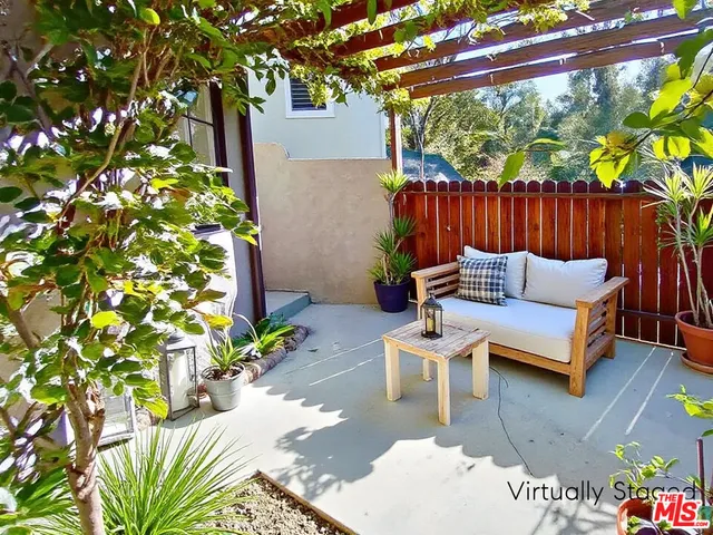 a outdoor living space with furniture and a potted plant