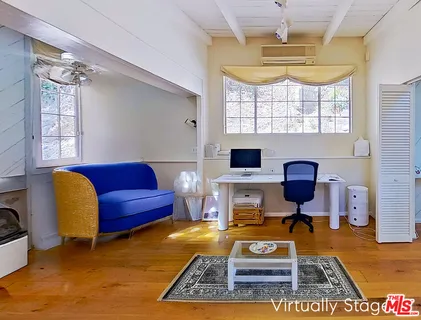 a view of a livingroom with couch and a window