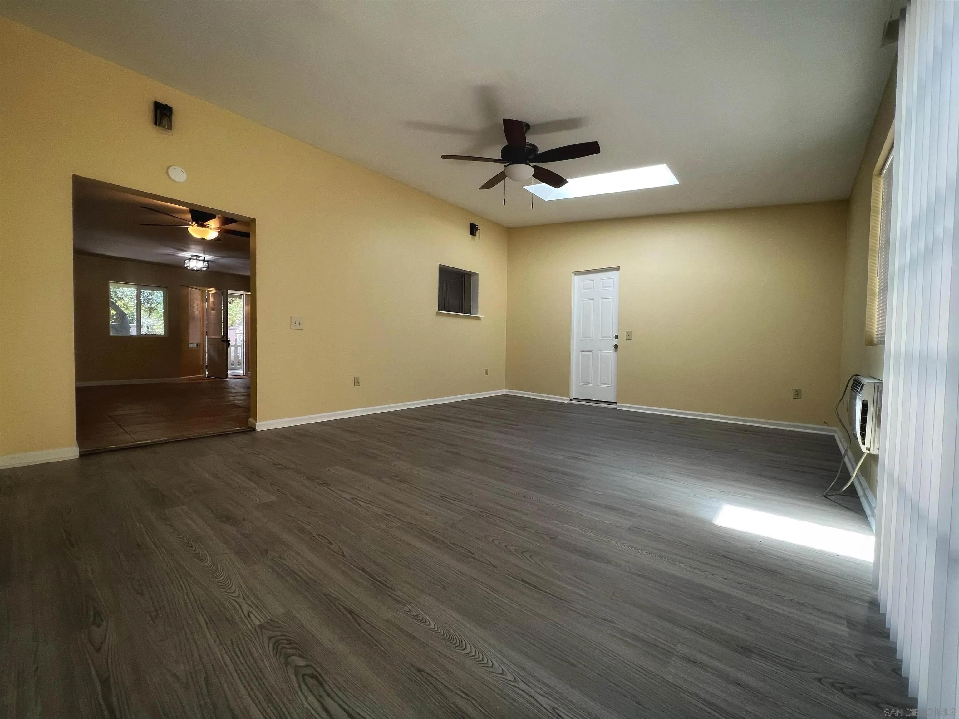 714 Convertible Lane Fallbrook, CA 92028 - Photo 11 of 28 an empty room with wooden floor and windows